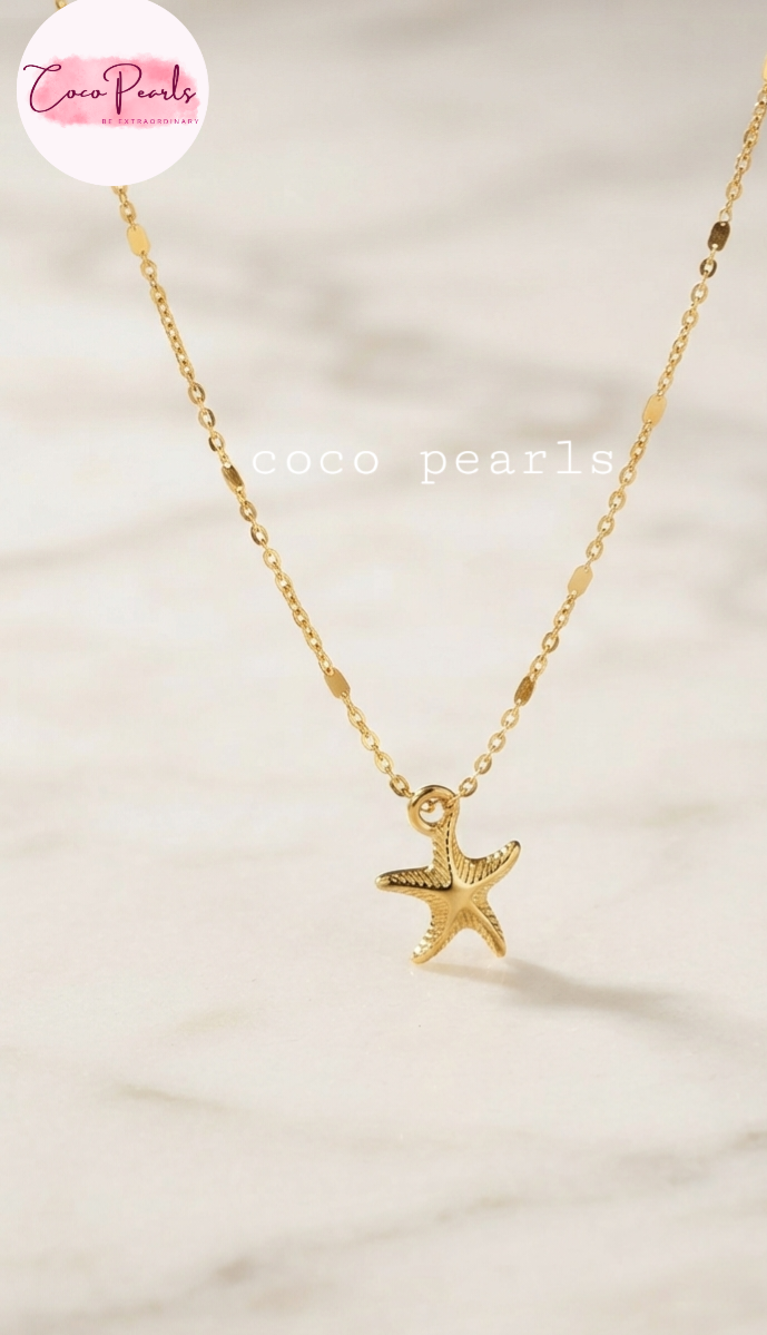 Coco pearls stainless Steel anti tarnish gold starfish pendant necklace on a delicate gold chain, displayed on a light marble surface.