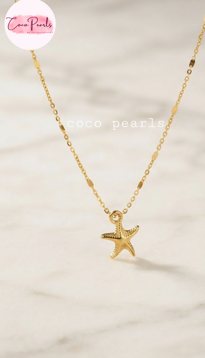 Coco pearls stainless Steel anti tarnish gold starfish pendant necklace on a delicate gold chain, displayed on a light marble surface.