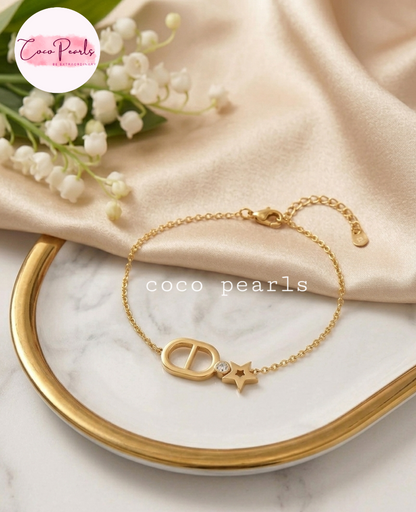 Coco pearls stainless Steel anti tarnish gold starlight widh bracelet with star and a stone  displayed on simple background 