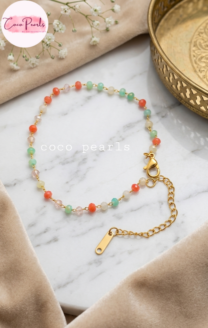 Coco pearls stainless Steel anti tarnish gold  sunset mist bracelet with colorful beads bracelet displayed simple background 
