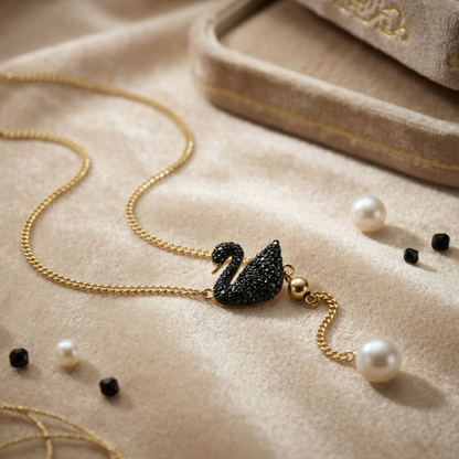 Coco pearls stainless Steel anti tarnish black swan with pearl hanging displayed on simple background 