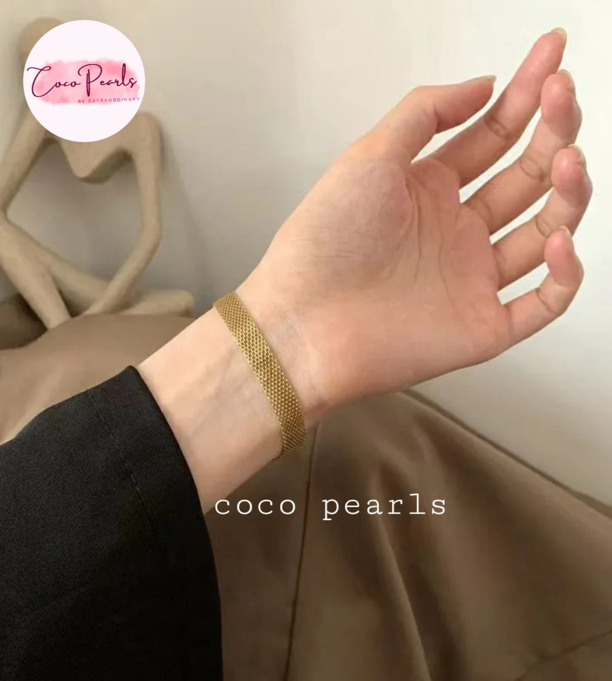 Coco pearls stainless Steel anti tarnish close-up of a person's wrist wearing a thin gold mesh bracelet