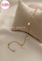 Coco pearls stainless Steel anti tarnish delicate gold chain anklet with three white freshwater pearls, displayed on a textured beige pillow against a soft beige fabric background.