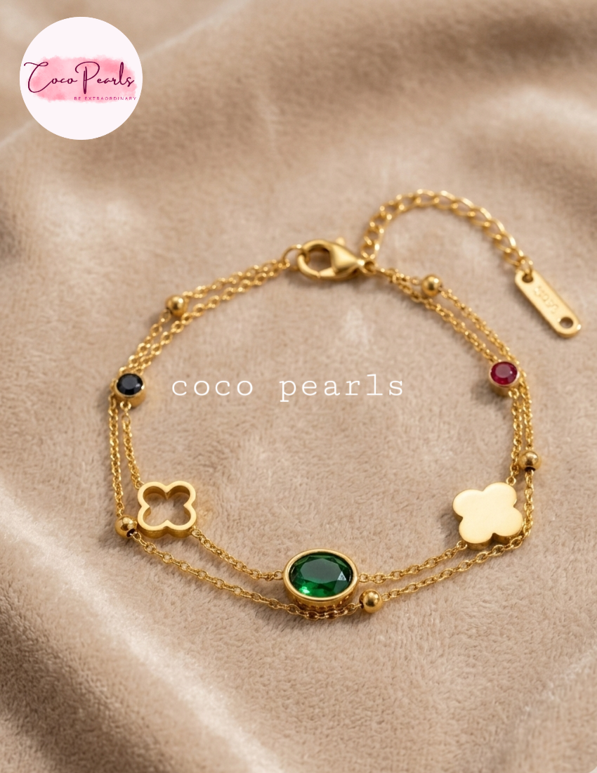 Coco pearls stainless Steel anti tarnish gold tri fortune bracelet displayed on simple background 