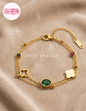 Coco pearls stainless Steel anti tarnish gold tri fortune bracelet displayed on simple background 