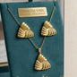 Coco pearls stainless Steel anti tarnish Gold jewelry set with gold trinity design with necklaces and earrings on a white background