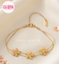 Coco pearls stainless Steel anti tarnish gold  triple flower bracelet with double chain displayed on simple background 