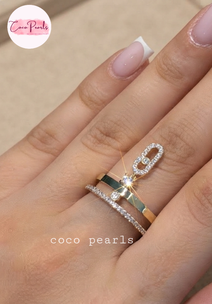 Coco pearls stainless Steel anti tarnish close-up of a hand wearin rings from Coco Pearls. Two layer ring one stone studded one plain. With a stone studded hanging