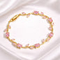 Coco pearls Gold bracelet with pink gemstones on a white background