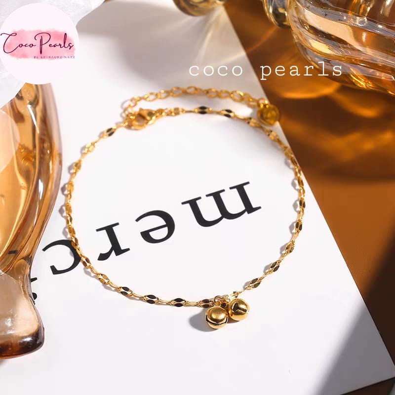 Coco pearls stainless Steel anti tarnish delicate gold chain bracelet with two small gold bell charms, displayed on a white card