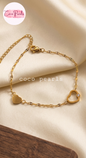 Coco pearls stainless Steel anti tarnish Gold bracelet with heart-shaped links on a beige fabric background, 
