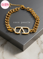 Coco pearls stainless Steel anti tarnish gold v-curb bracelet displayed on simple background 