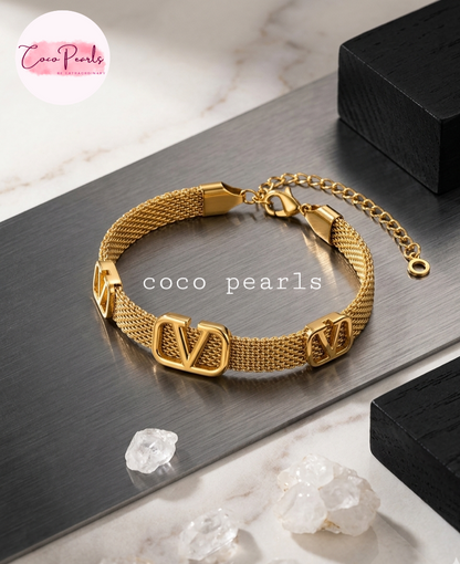 Coco pearls stainless Steel anti tarnish gold v mesh bracelet displayed on simple background 