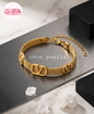 Coco pearls stainless Steel anti tarnish gold v mesh bracelet displayed on simple background 