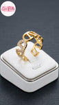 Coco pearls stainless Steel anti tarnish gold ring with a heart-shaped design paved with small clear stones, displayed on a white ring box against a dark gray background.