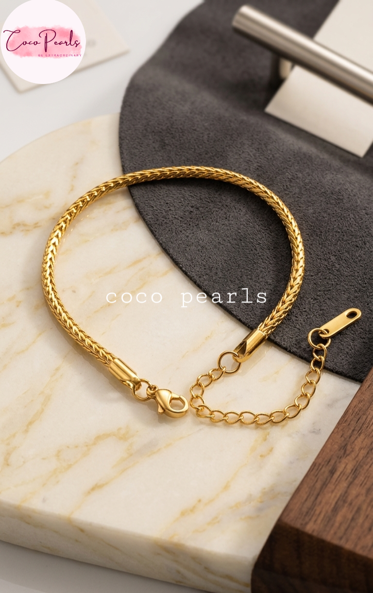 Coco pearls stainless Steel anti tarnish gold wheat braid bracelet displayed on simple background 
