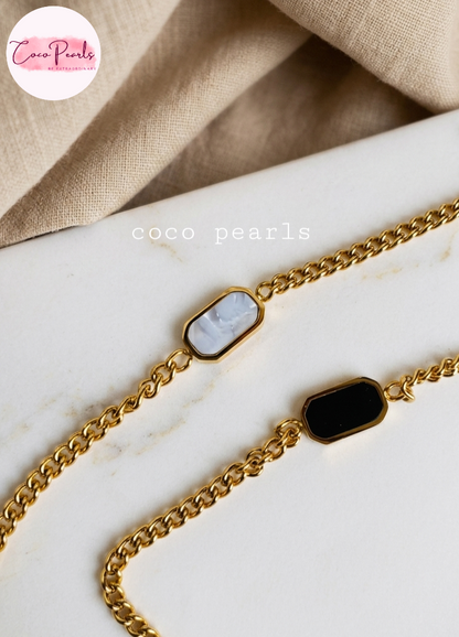 Coco pearls stainless Steel anti tarnish gold  white whisper bracelet displayed on simple background 