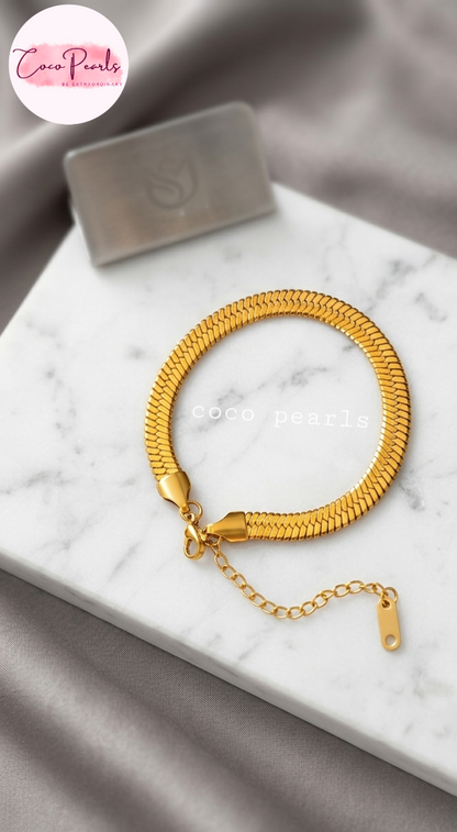 Coco pearls stainless Steel anti tarnish gold snake chain wide bracelet displayed on simple background 
