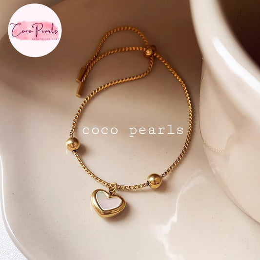 Coco pearls stainless Steel anti tarnish gold wish heart bracelet with white heart charm displayed on simple background