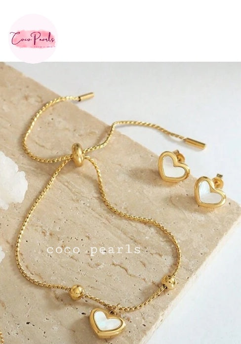 Coco pearls stainless Steel anti tarnish gold wish heart bracelet with heart charm in center displayed on simple background 
