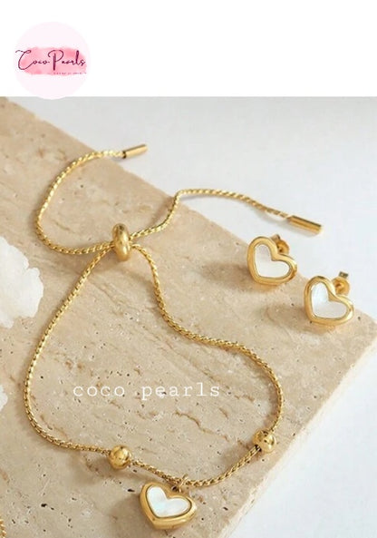 Coco pearls stainless Steel anti tarnish gold wish heart bracelet with heart charm in center displayed on simple background 