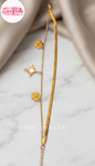 Coco pearls stainless Steel anti tarnish Gold wish upon bracelet with star and clover charms on a marble surface,