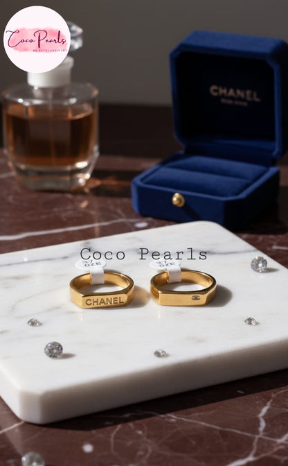 Coco Pearls Stainless Steel Anti Tarnish Gold aurum link ring with  Chanel written on a marble surface 