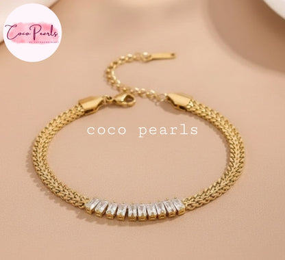 Coco Pearls Stainless steel Anti Tarnish Gold aurum spark bracelet with clear stones on a beige background