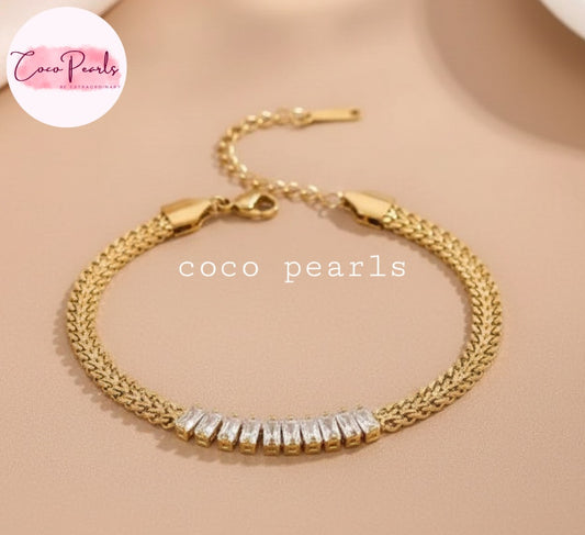 Coco Pearls Stainless steel Anti Tarnish Gold aurum spark bracelet with clear stones on a beige background