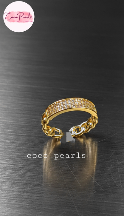 coco pearls stainless steel anti tarnish gold azure grid adjustable diamond studded ring displayed on metallic surface