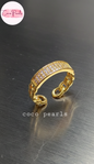 coco pearls stainless steel anti tarnish gold azure grid adjustable diamond studded ring displayed on silver surface