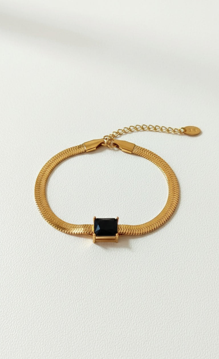 Coco Pearls Stainless Steel Anti Tarnish Gold black accent bracelet with a black gemstone on a white background
