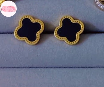 Coco Pearls Stainless Steel Anti Tarnish Black clover-shaped earrings with gold outlines on a light blue background