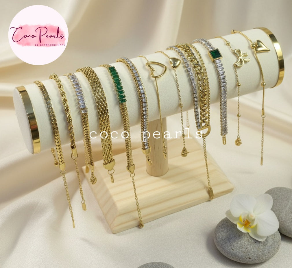 Coco Pearls Stainless steel Anti Tarnish Gold bracelets with different bracelets stacked on a stand