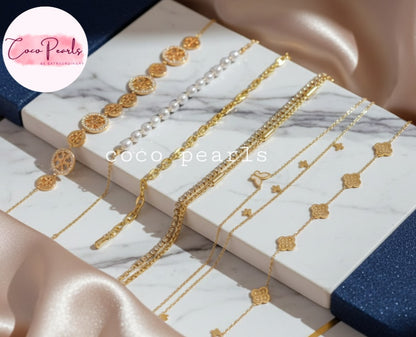 Coco Pearls Stainless Steel Anti Tarnish gold Bracelet of different designs displayed on a marble surface