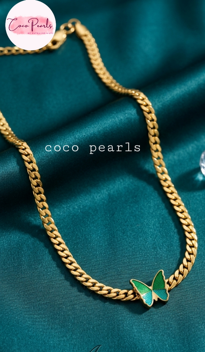 coco pearls stainless steel anti tarnish Gold chain necklace with a green butterfly pendant on fabric