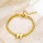 Coco Pearls Stainless Steel Anti Tarnish Gold butterfly bliss bracelet with a butterfly charm mesh chain on a beige background