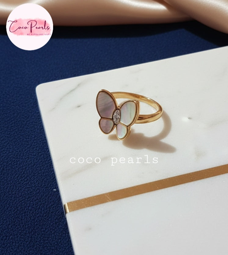 Coco Pearls Stainless Steel Anti Tarnish Butterfly-shaped ring with clear gemstones on a marble surface