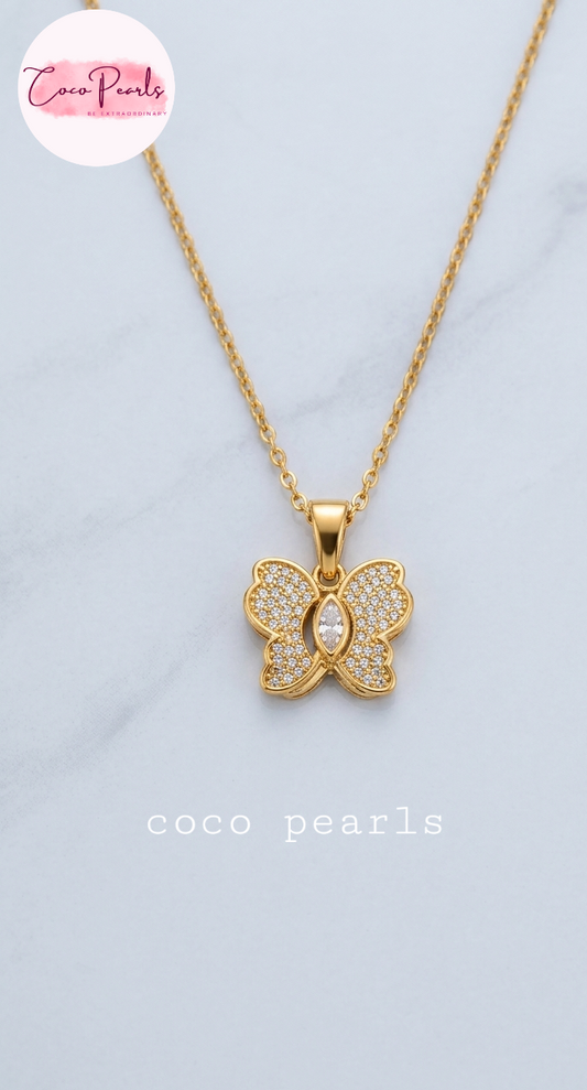 coco pearls stainless steel pakistan anti tarnish waterproof Gold butterfly sparkle necklace with diamond studded butterfly pendant on a light background