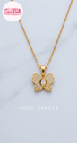 coco pearls stainless steel pakistan anti tarnish waterproof Gold butterfly sparkle necklace with diamond studded butterfly pendant on a light background