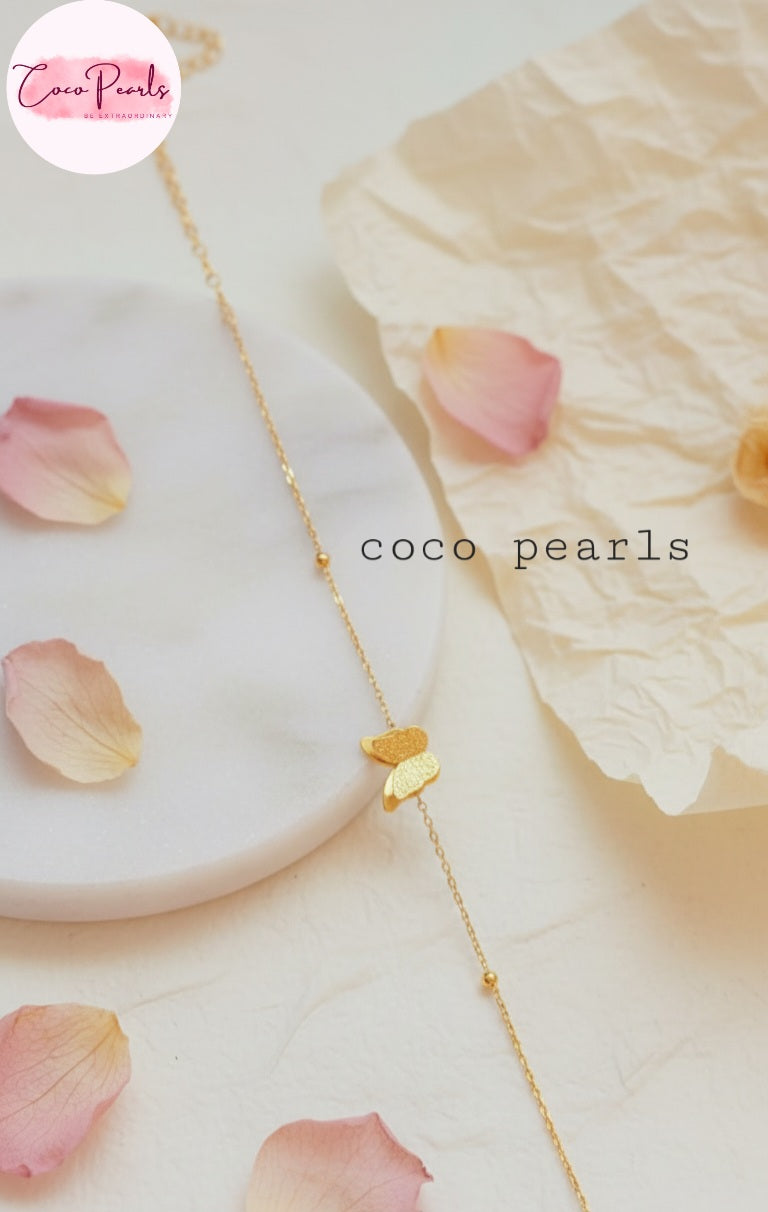 Coco Pearls Stainless Steel Anti Tarnish Gold butterfly whisper bracelet with double butterfly charm on a light background