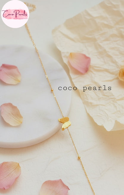 Coco Pearls Stainless Steel Anti Tarnish Gold butterfly whisper bracelet with double butterfly charm on a light background