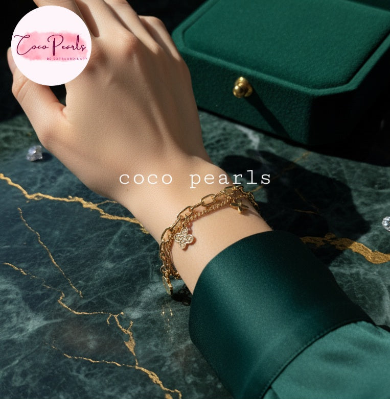 Coco Pearls Stainless steel anti tarnish Gold layered bracelet on a wrist with a green background