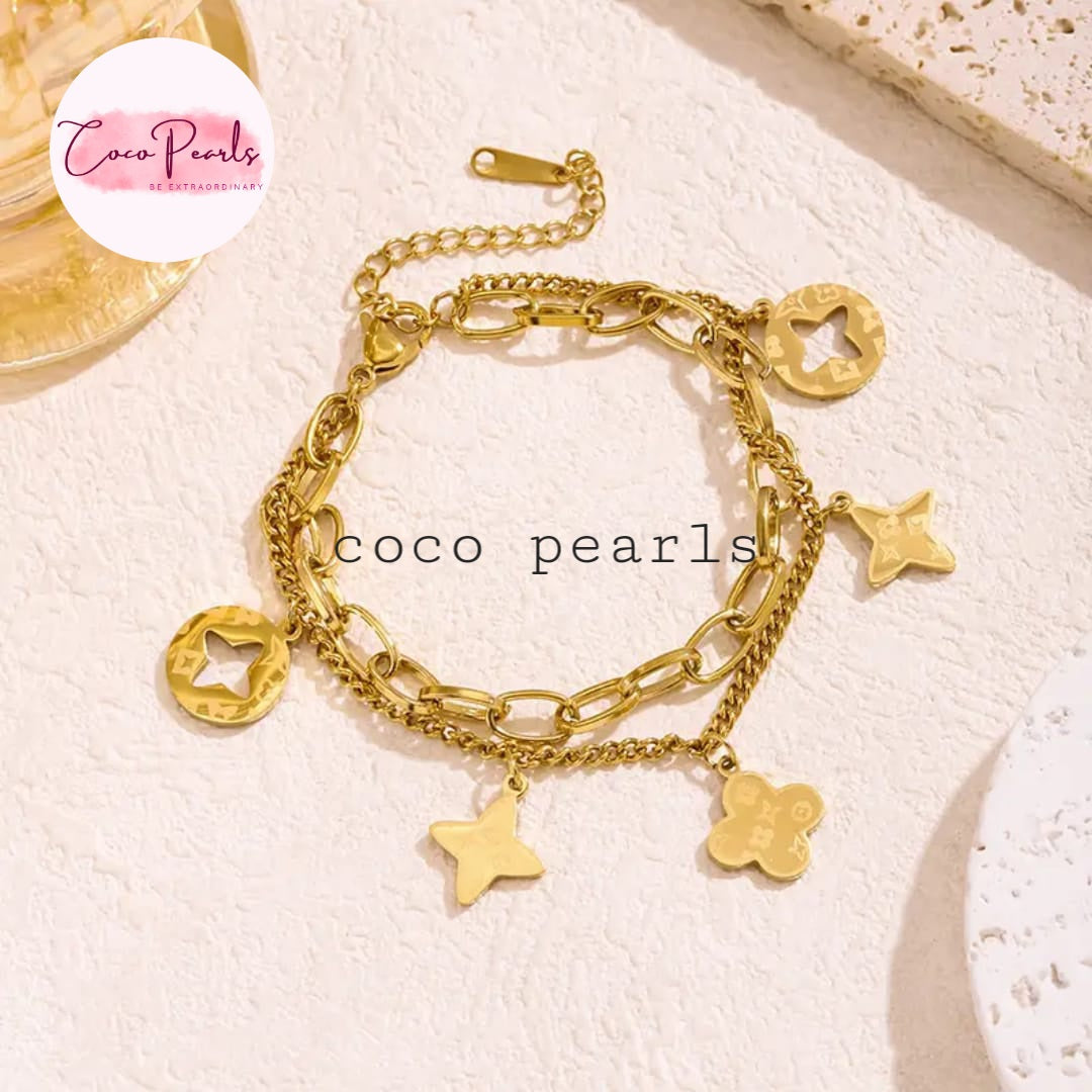 Coco Pearls Stainless steel anti tarnish Gold charm layered bracelet with charms on a light background