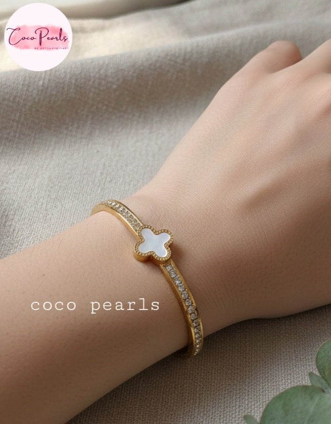 Coco Pearls Stainless Steel Anti tarnish gold clover luxe handcuff with zircon on sides and clover in center worn on wrist