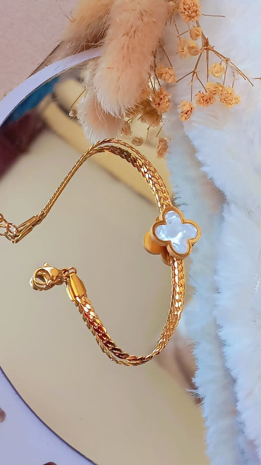 Coco Pearls Stainless Steel Anti Tarnish Gold clover charm bracelet with a clover-shaped clasp mesh chain on a soft white background
