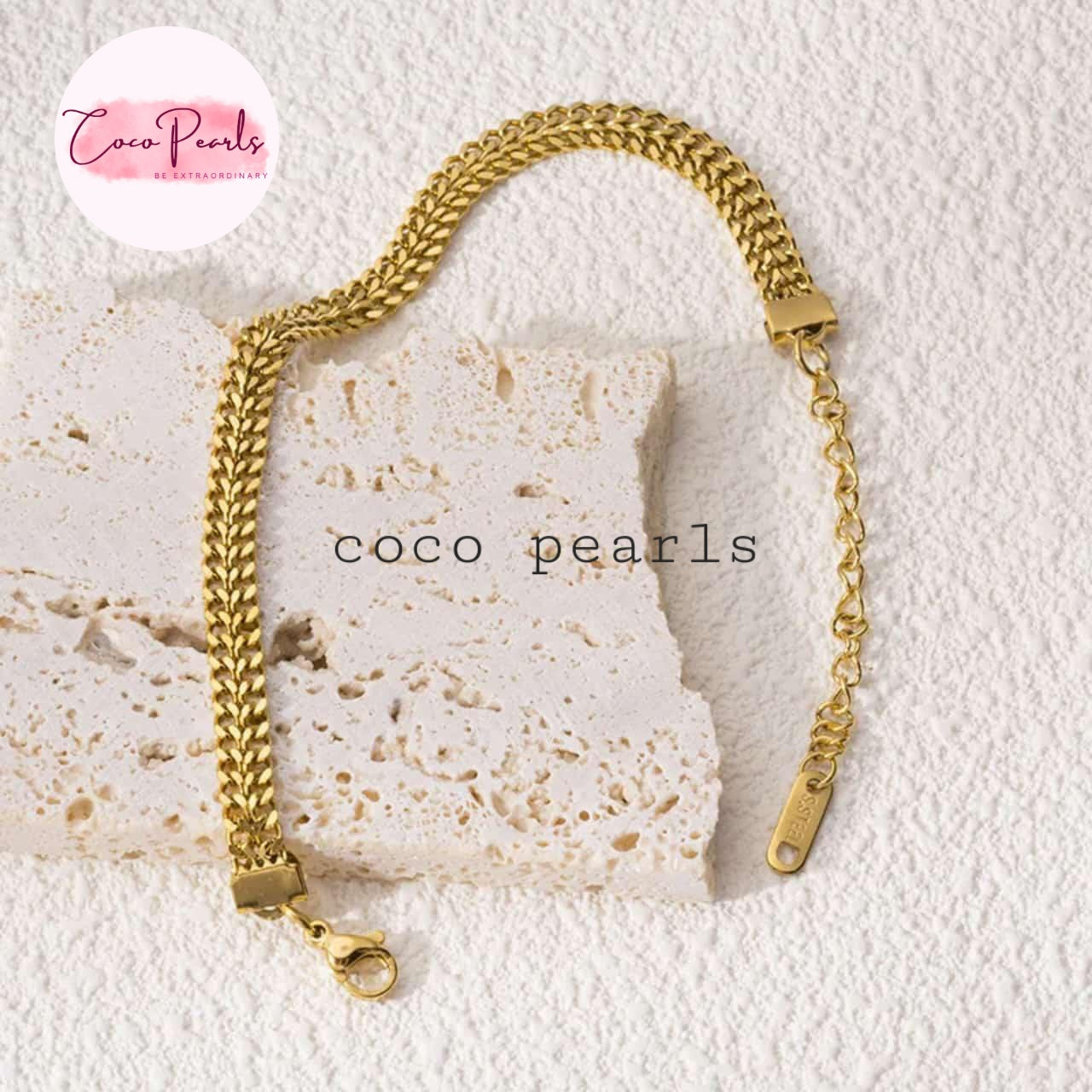 Coco Pearls Stainless steel anti tarnish Gold mesh chain bracelet on a textured stone surface.