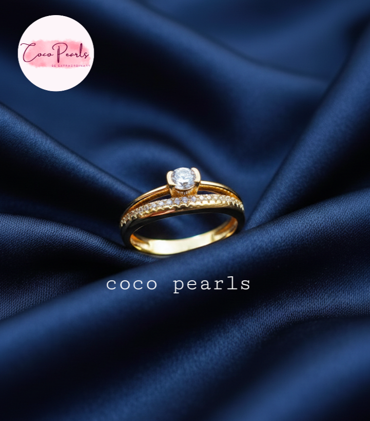 coco pearls stainless steel anti tarnish gold crown solitaire adjustable diamond studded ring displayed on blue satin
