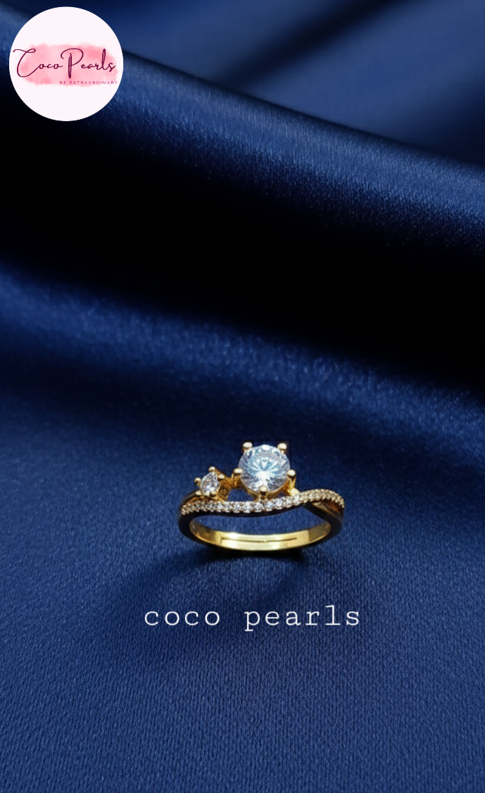 coco pearls stainless steel anti tarnish gold crown spark adjustable diamond studded ring displayed on blue satin