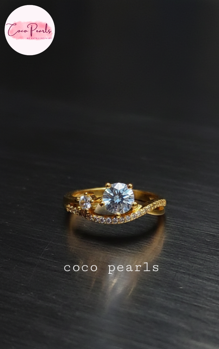 coco pearls stainless steel anti tarnish gold crown spark adjustable diamond studded ring a big diamond in center displayed on metallic surface